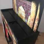 There is a slot between the back panel and the body of the theatre